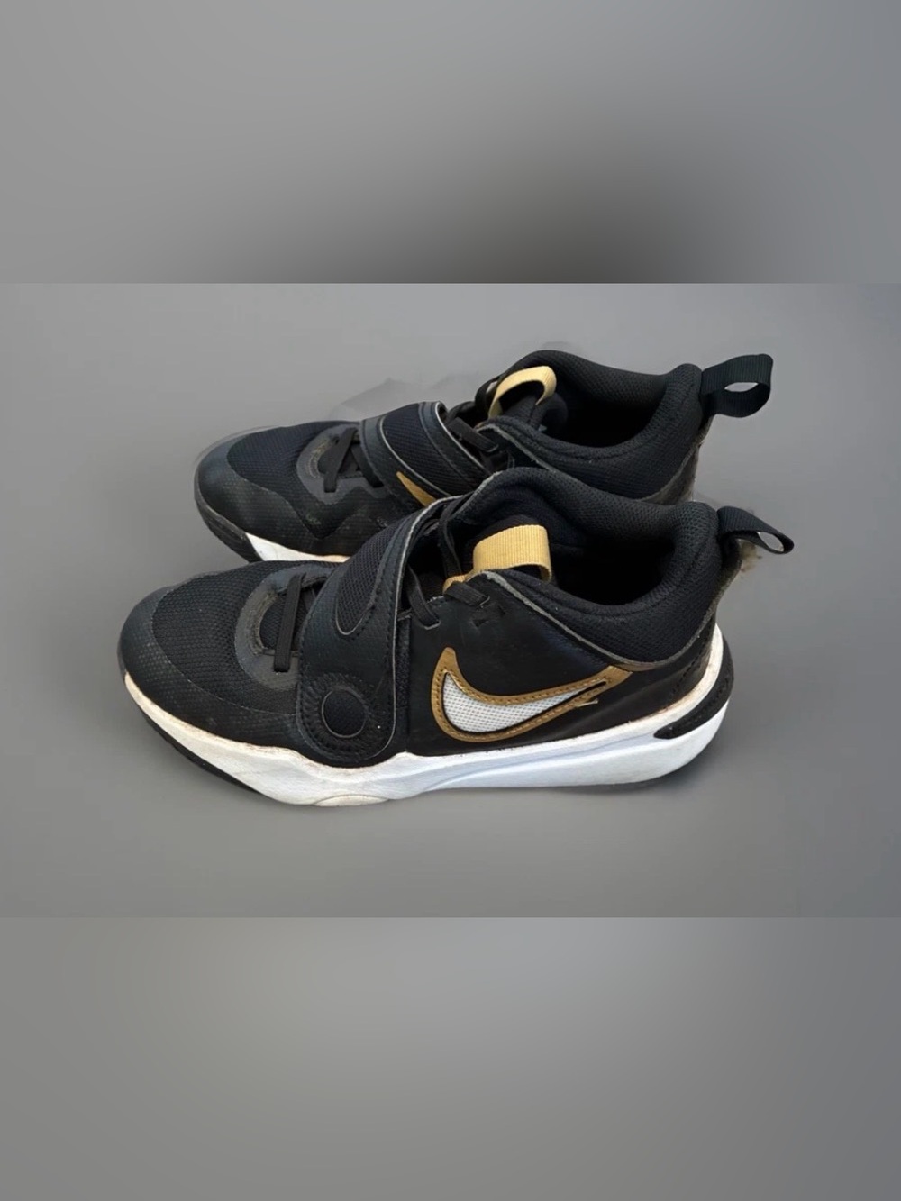 Nike Team Hustle D11 Black and Gold Slip-On Performance Sneakers